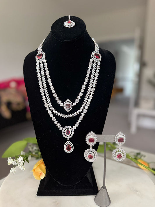 Exquisite 3 Layered Silver Toned Red Stone Studded Pendant Necklace Set with Mang Tikka and Flower Design Earrings